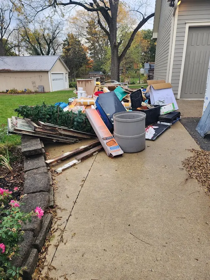 Dumpster being loaded with debris for Estate Cleanout Dumpster Rental in Malverne